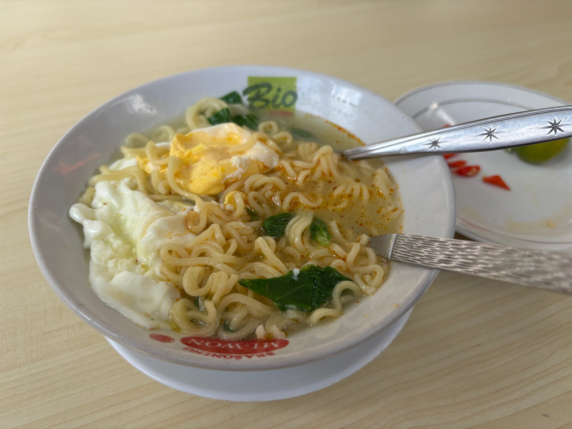 A bowl of Sarumento, instant noodles mixed with fried egg