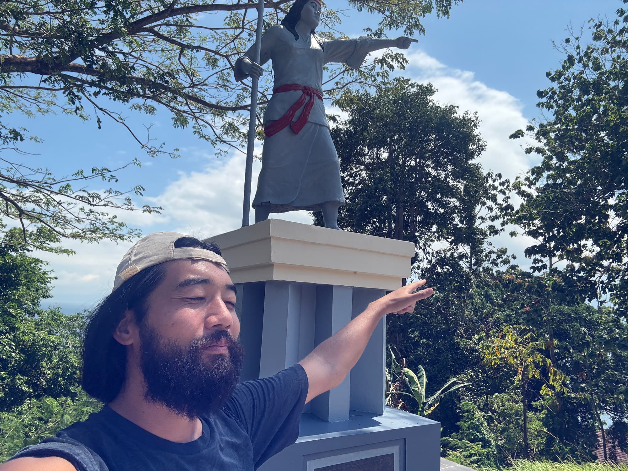 Posing next to a historical monument on the museum grounds