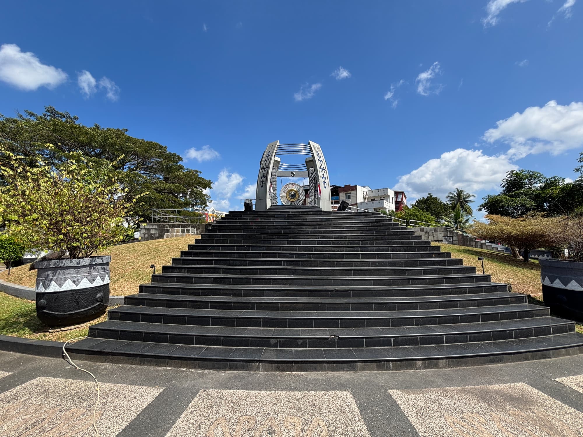 A wide view of the World Peace Gong monument under its circular canopy