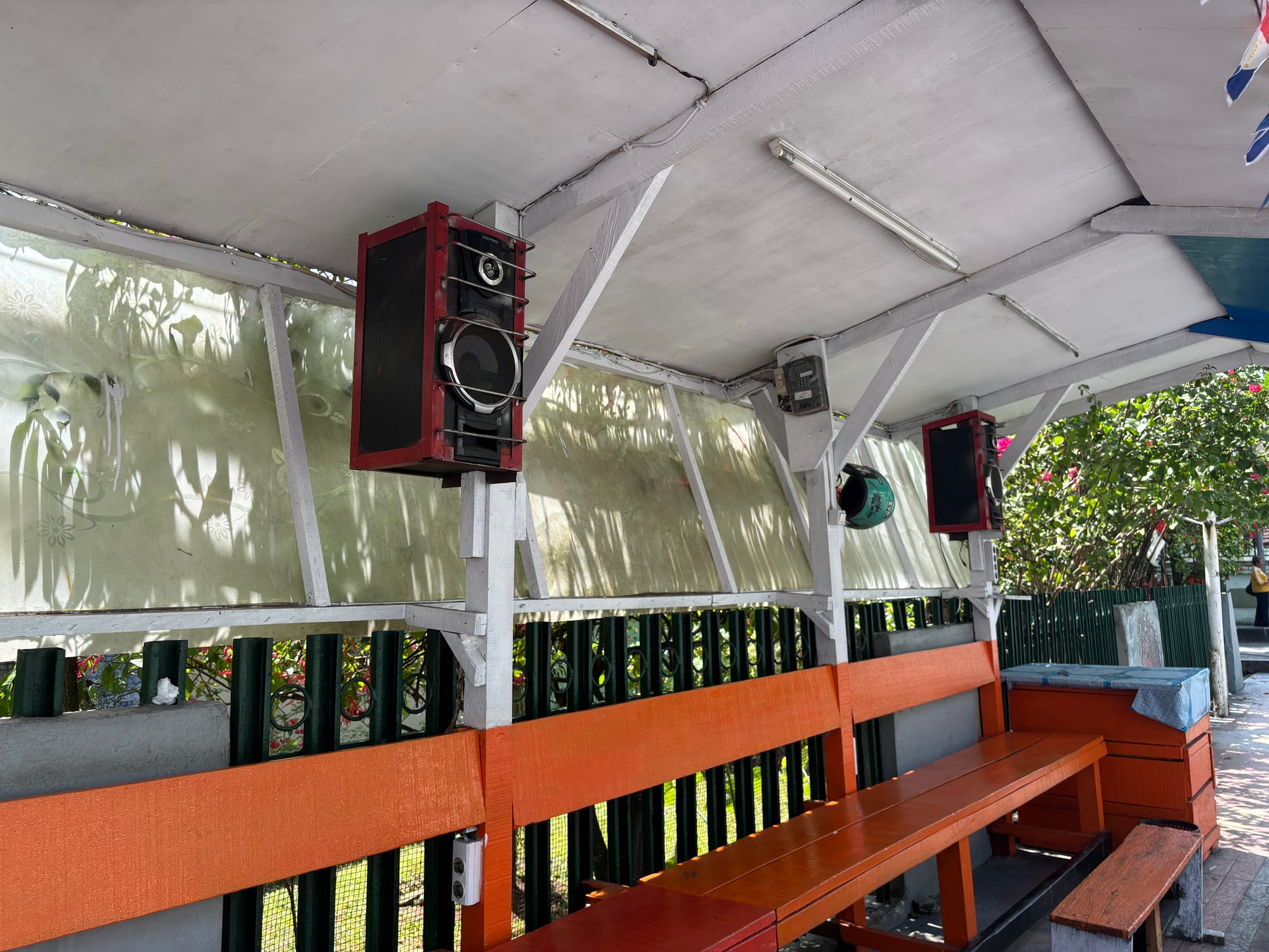 Large speakers mounted inside a bus stop shelter