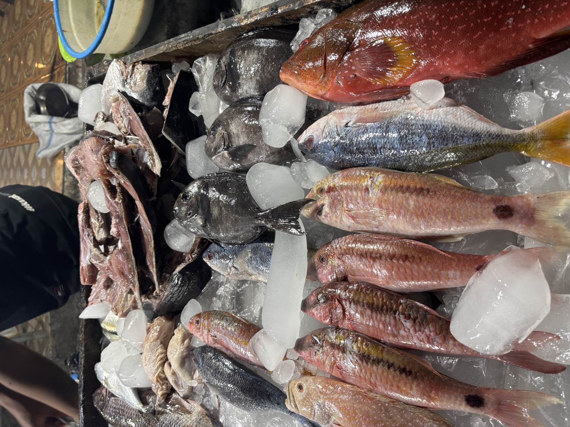 A colorful display of fresh fish on ice at the seafood stall