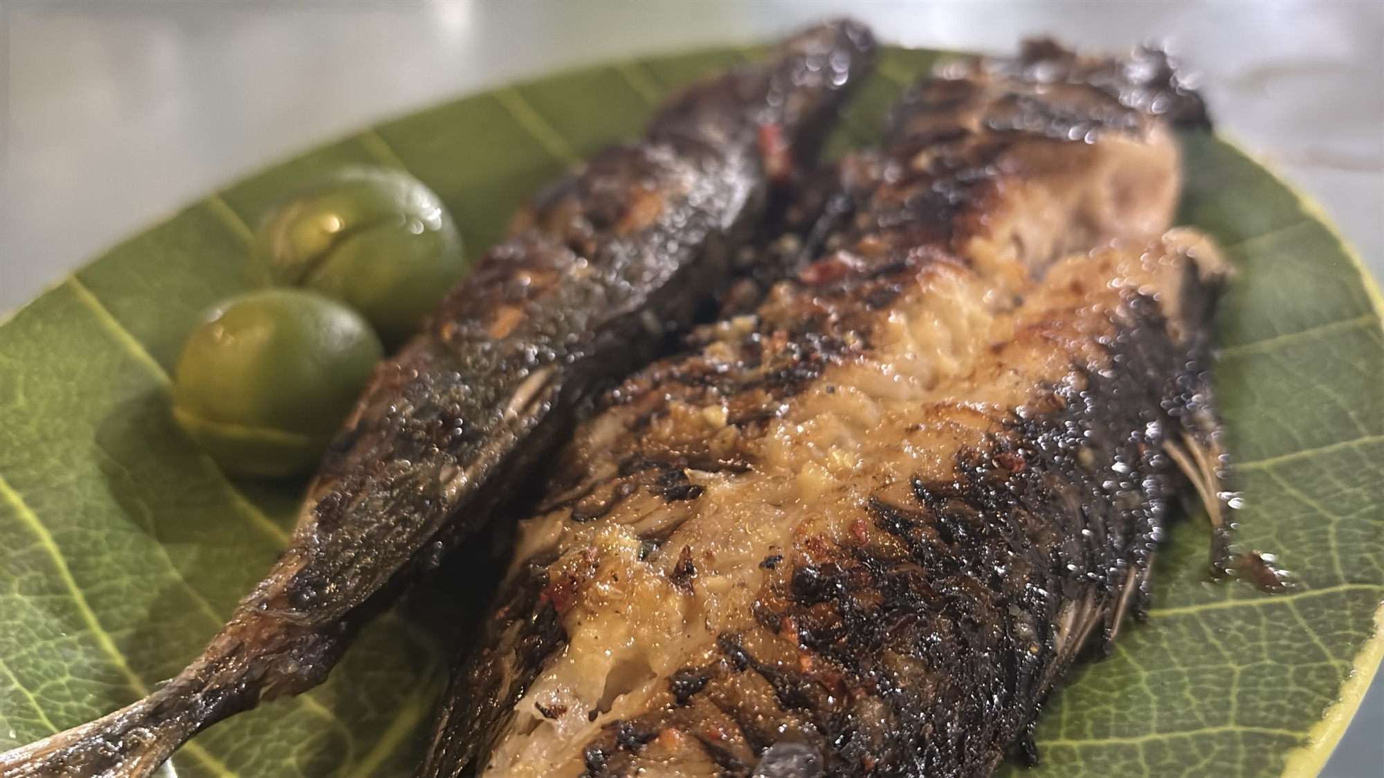 Grilled fish served on a banana leaf for dinner