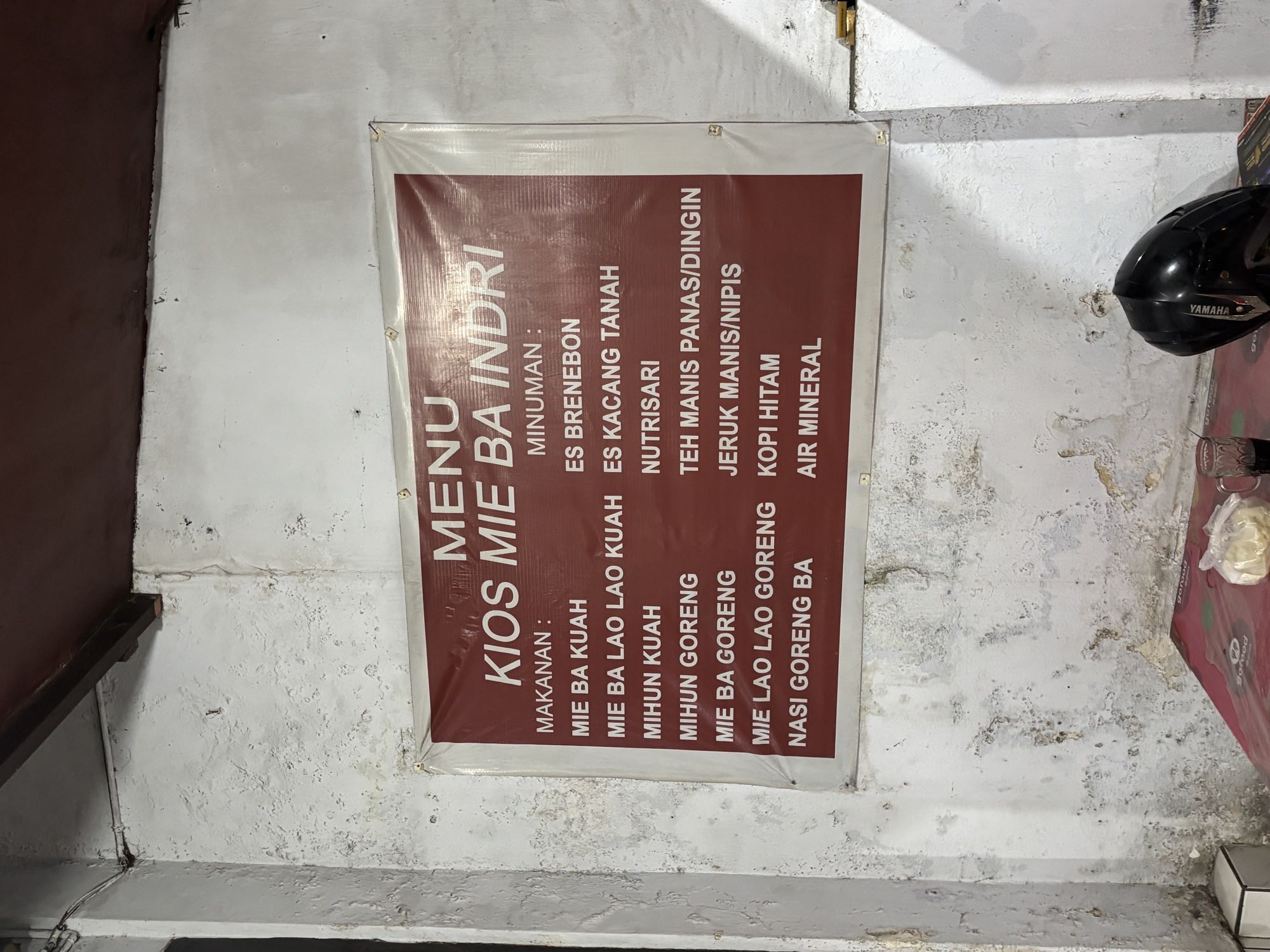 The menu board at a small Mie Ba Kuah kiosk in Manado