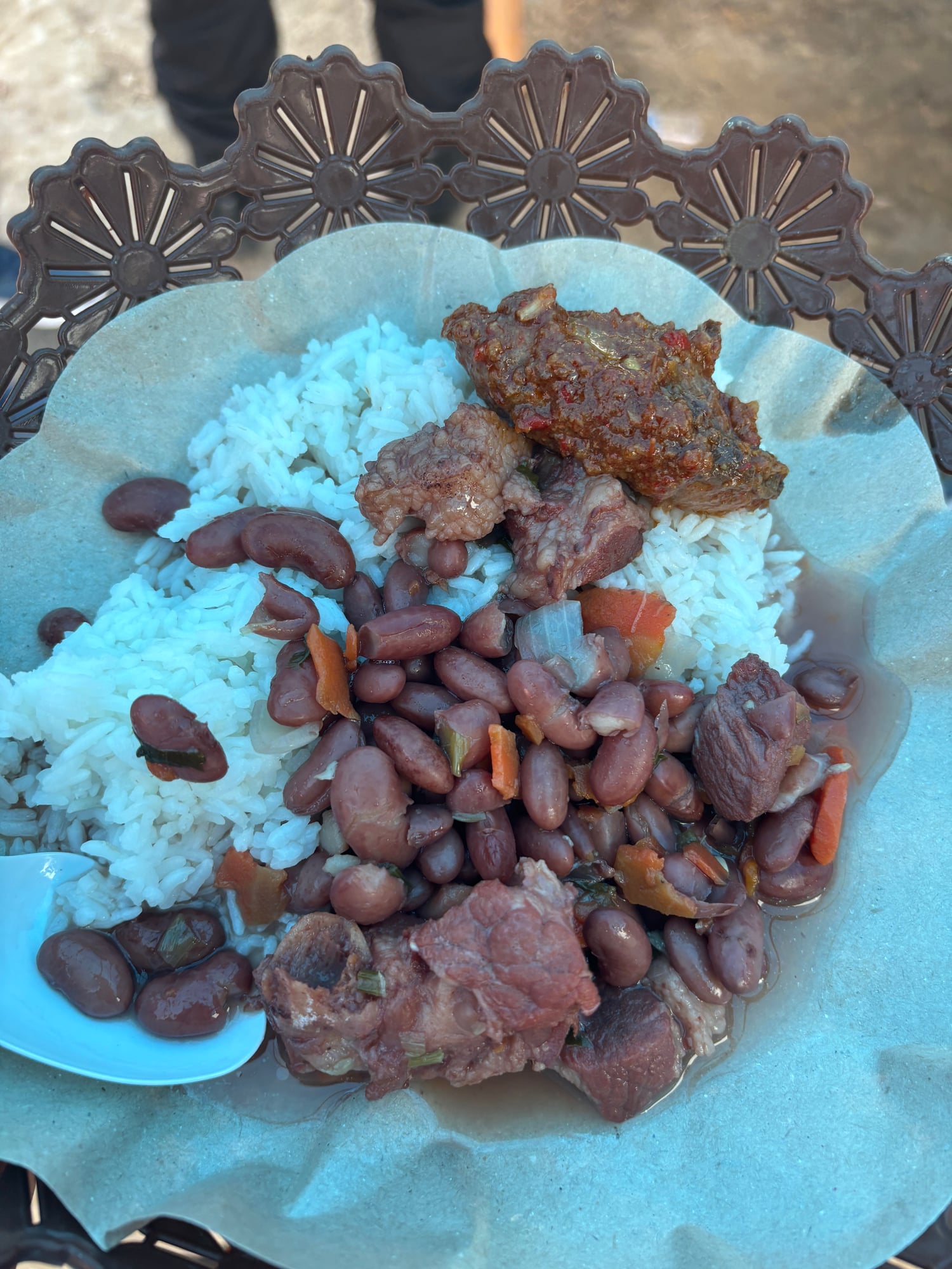 A plate of Sup Brenebon, rice, and meat with red kidney beans