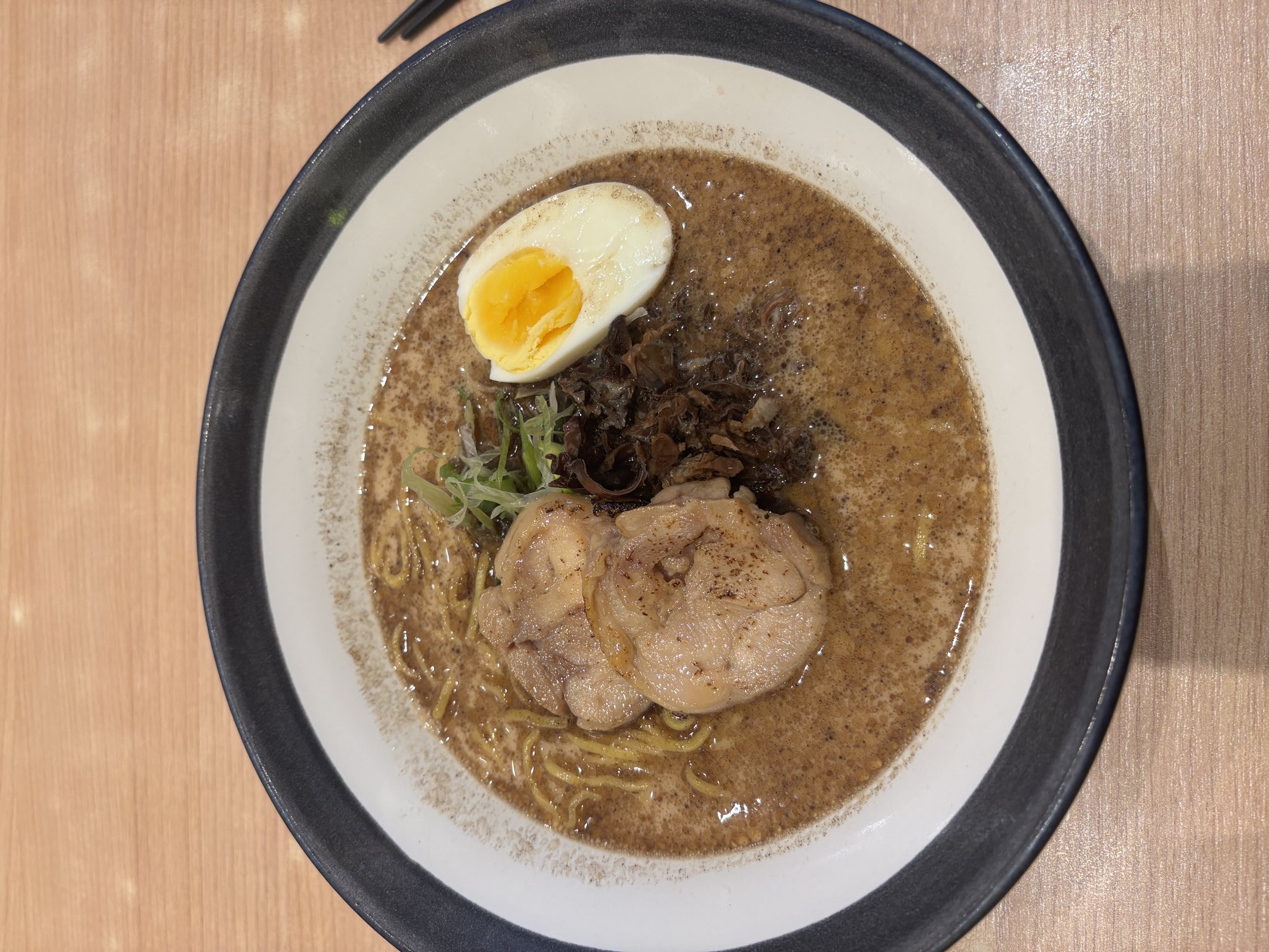A bowl of pork-free butter ramen topped with beef, egg, and wood ear mushrooms in Palu