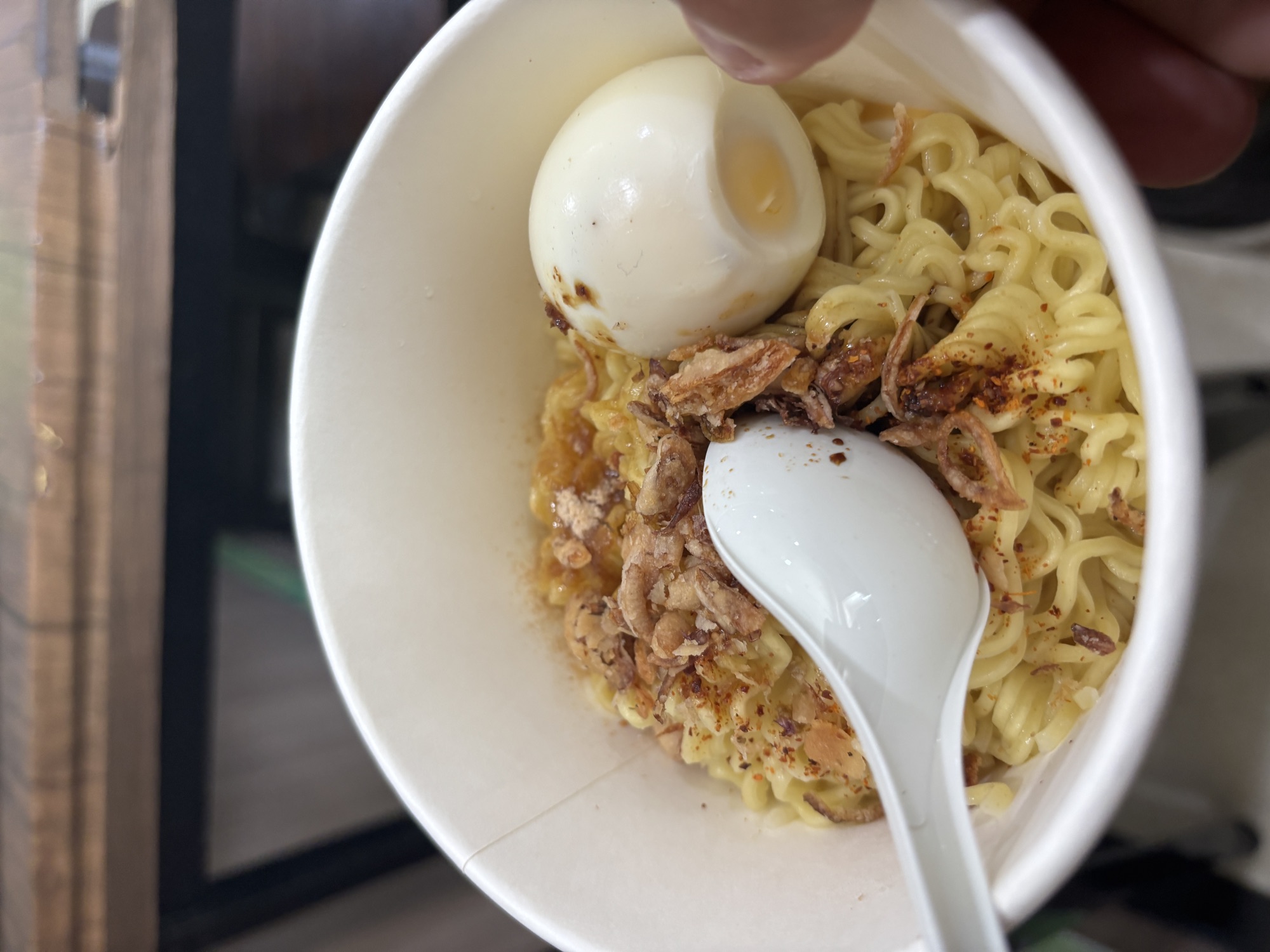 A bowl of Indomie Telur, instant noodles with egg, for lunch on the ferry