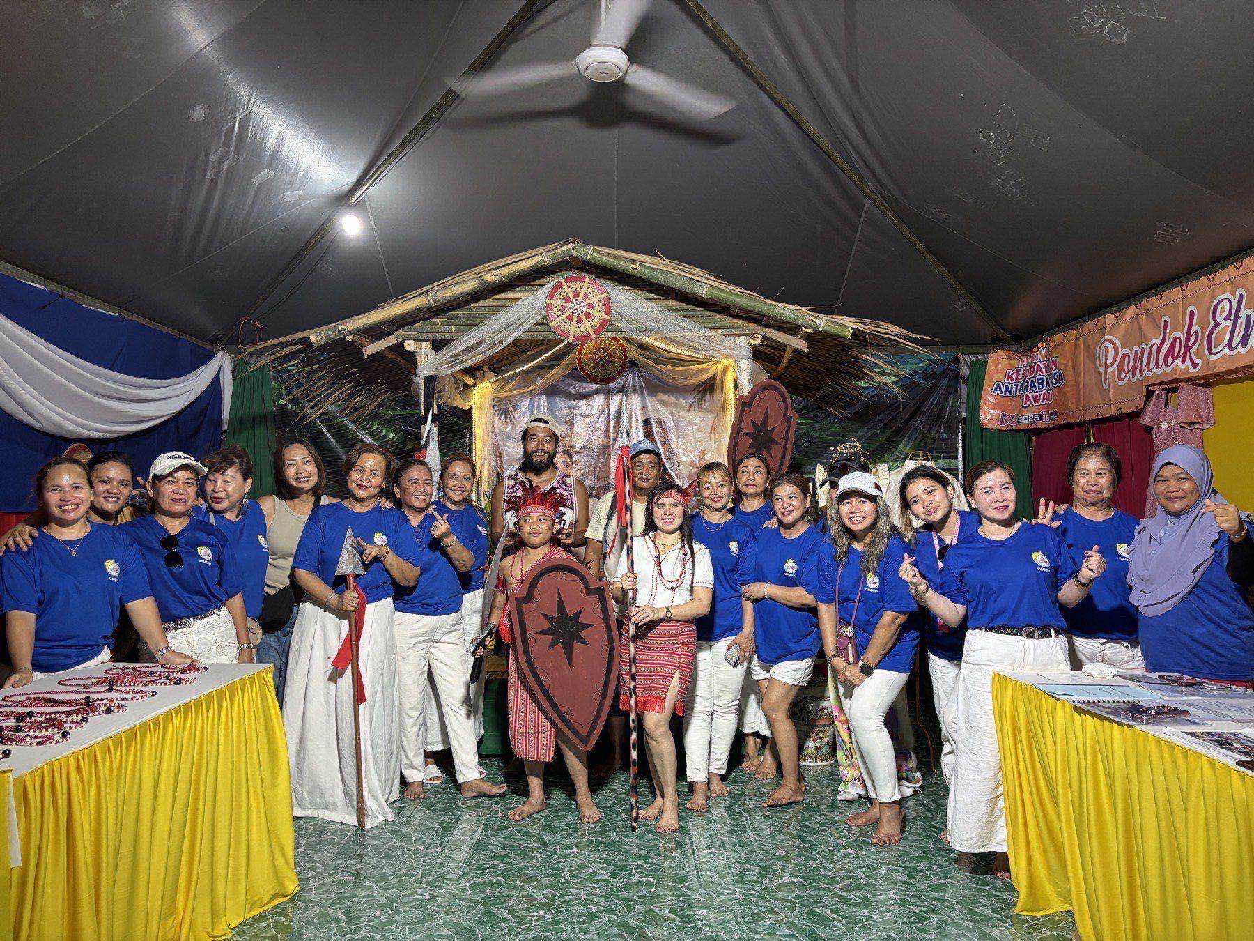 A group photo with the Filipino "Kababayan" community at their festival booth