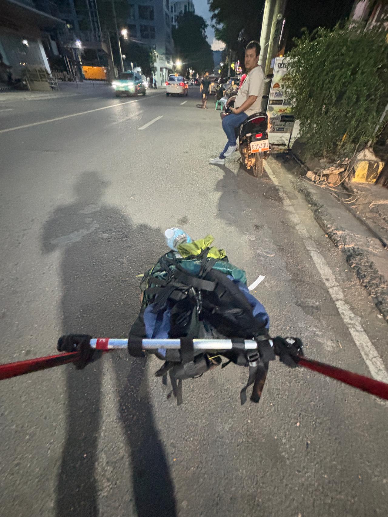 Walking through the dark streets of Cebu City at night with the trailer in tow.