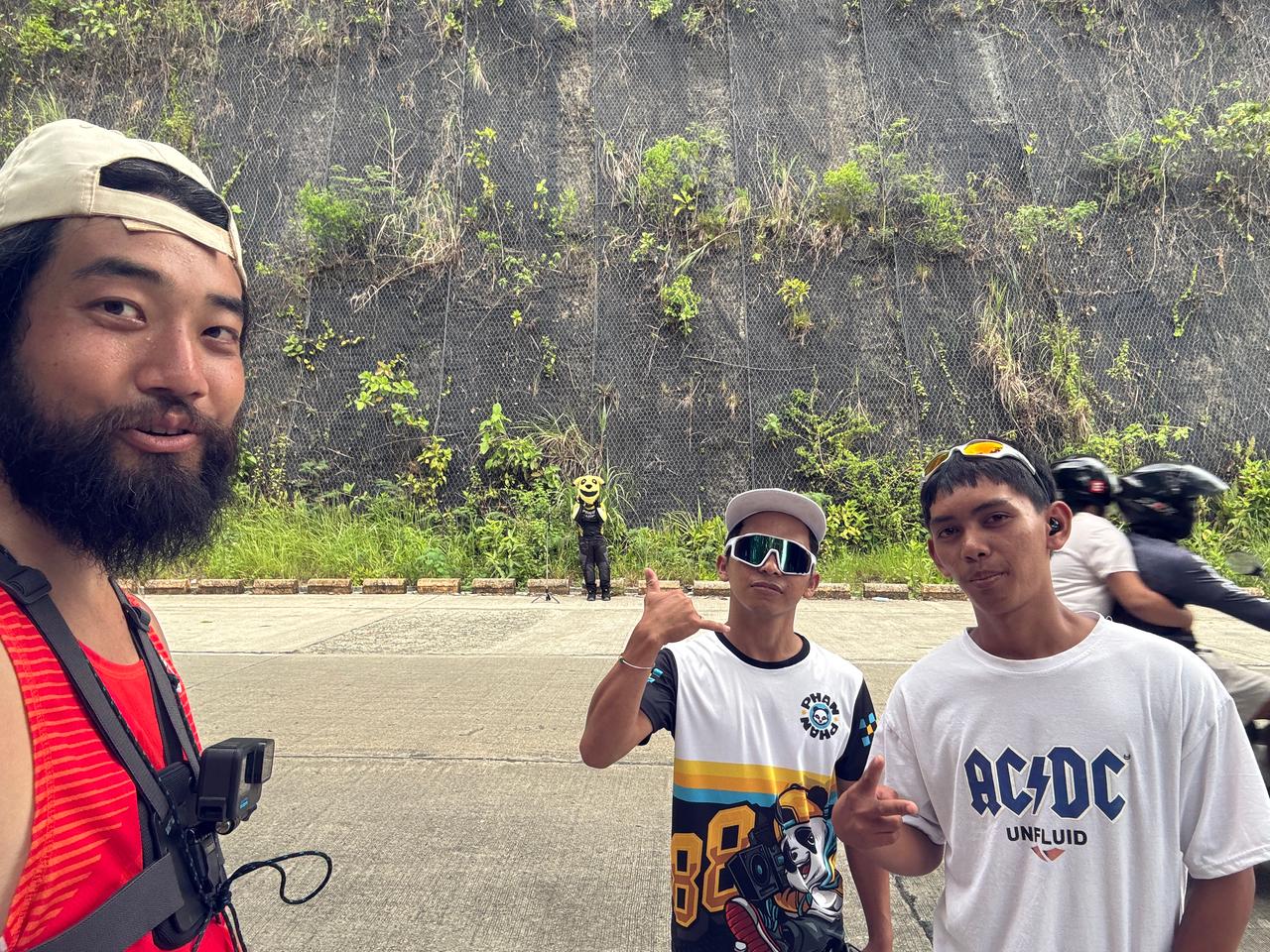 Content creators filming on the road during the descent