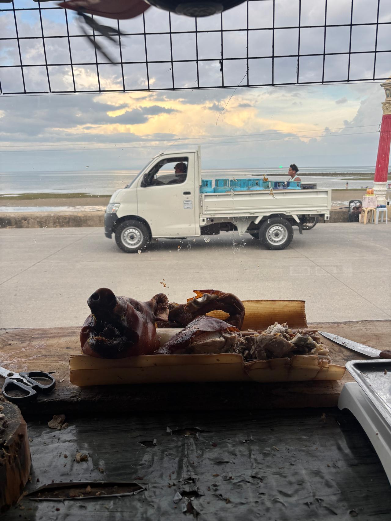 A whole roasted lechon displayed outside a shop in Guihulngan