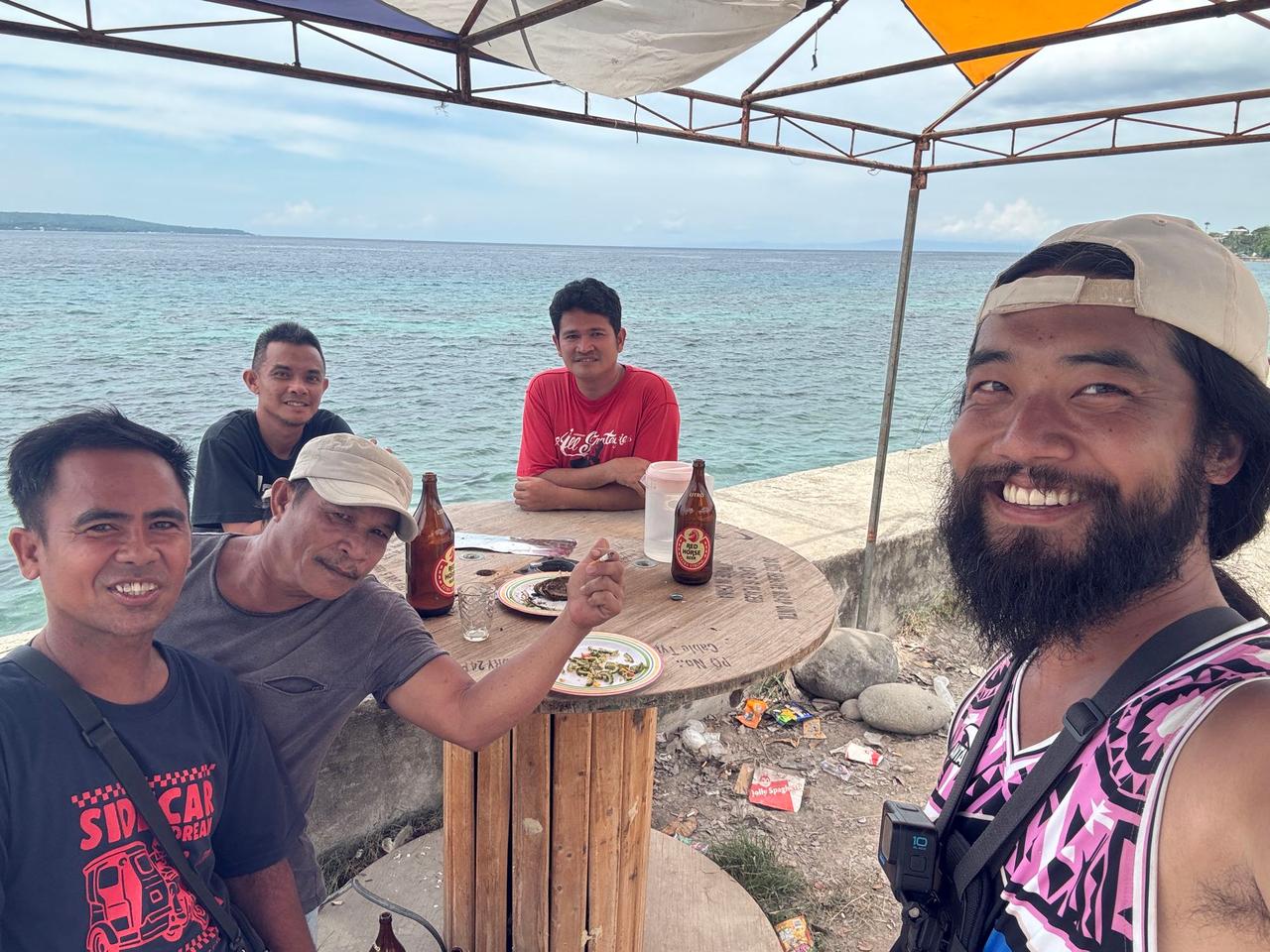 Sharing beers with a group of local dads at a seaside table on Father's Day