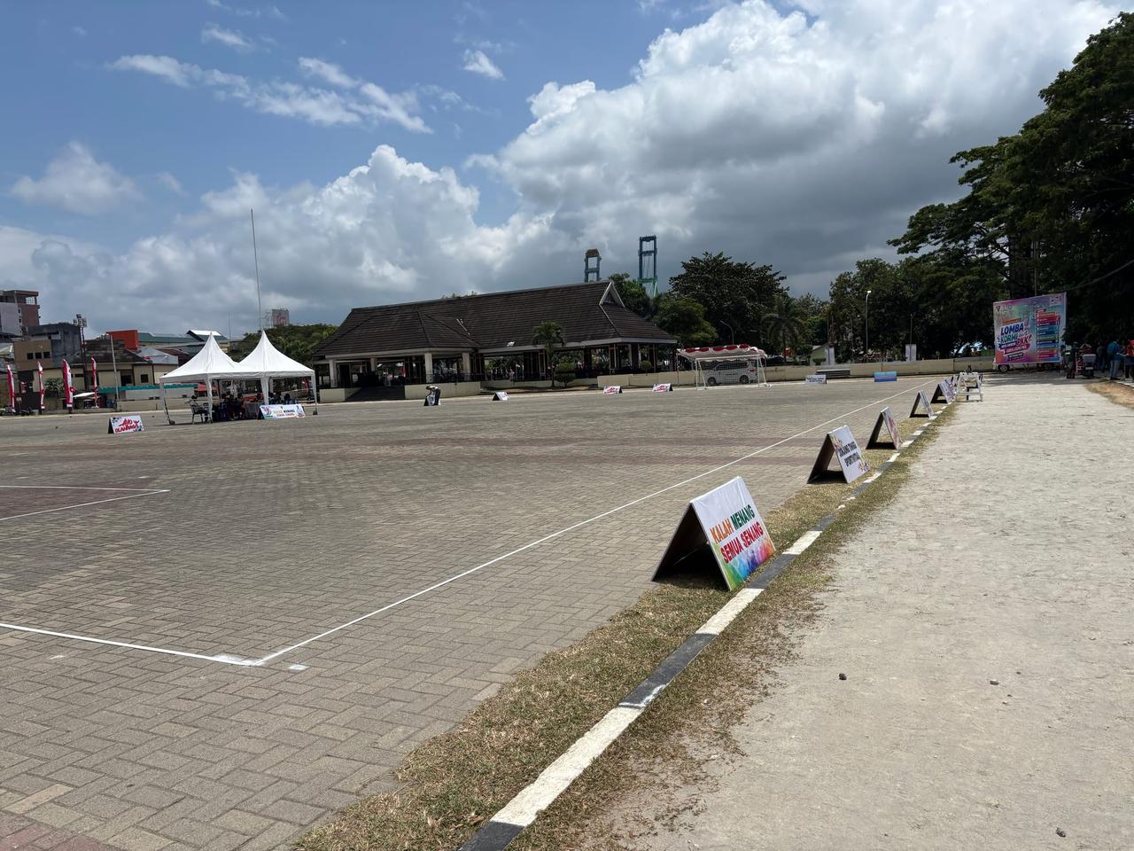 An empty paved sports court set up for an afternoon event