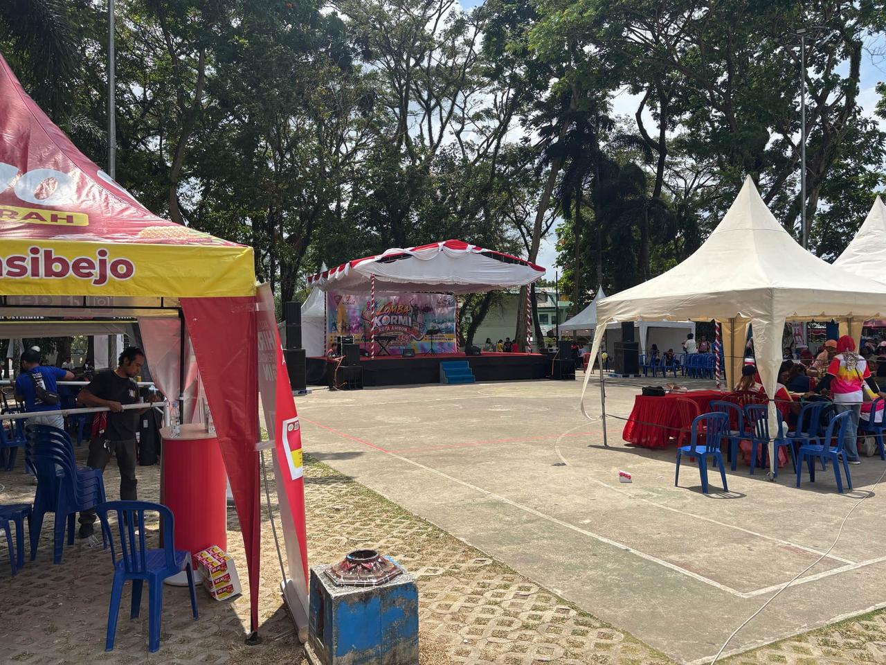 Tents and a stage being set up for the afternoon event