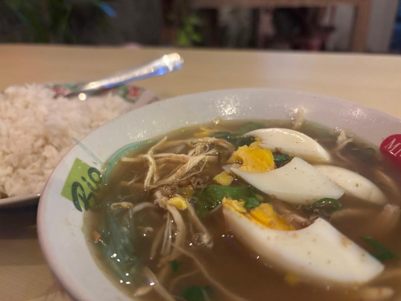 A bowl of chicken soup with egg and rice for dinner back at the hotel