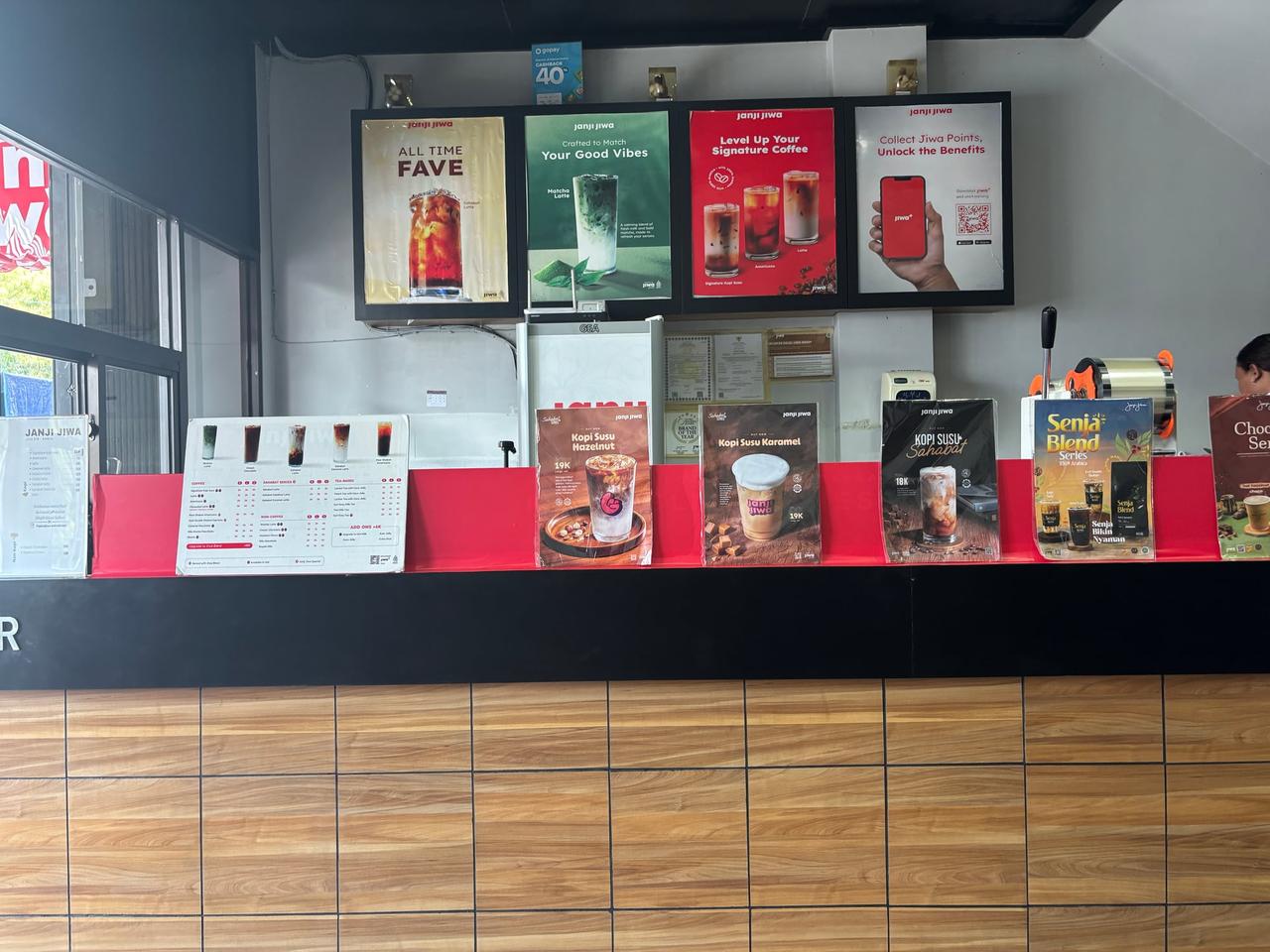 A coffee shop's menu boards displaying various coffee drinks