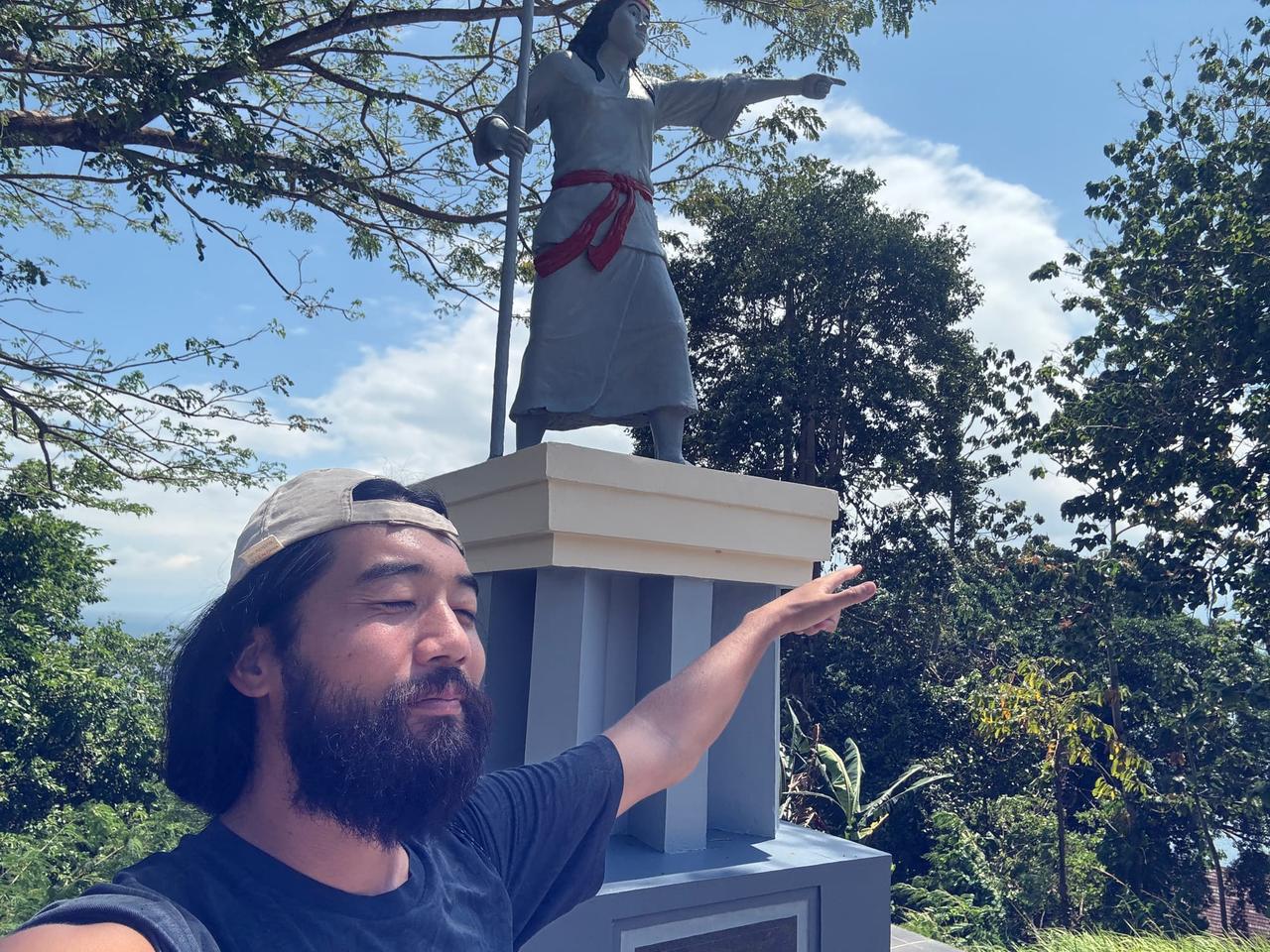 Posing next to a historical monument on the museum grounds
