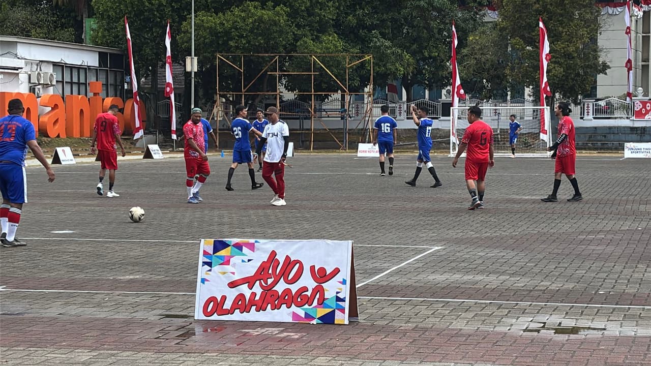 Men playing a "no-running" soccer match on an outdoor court