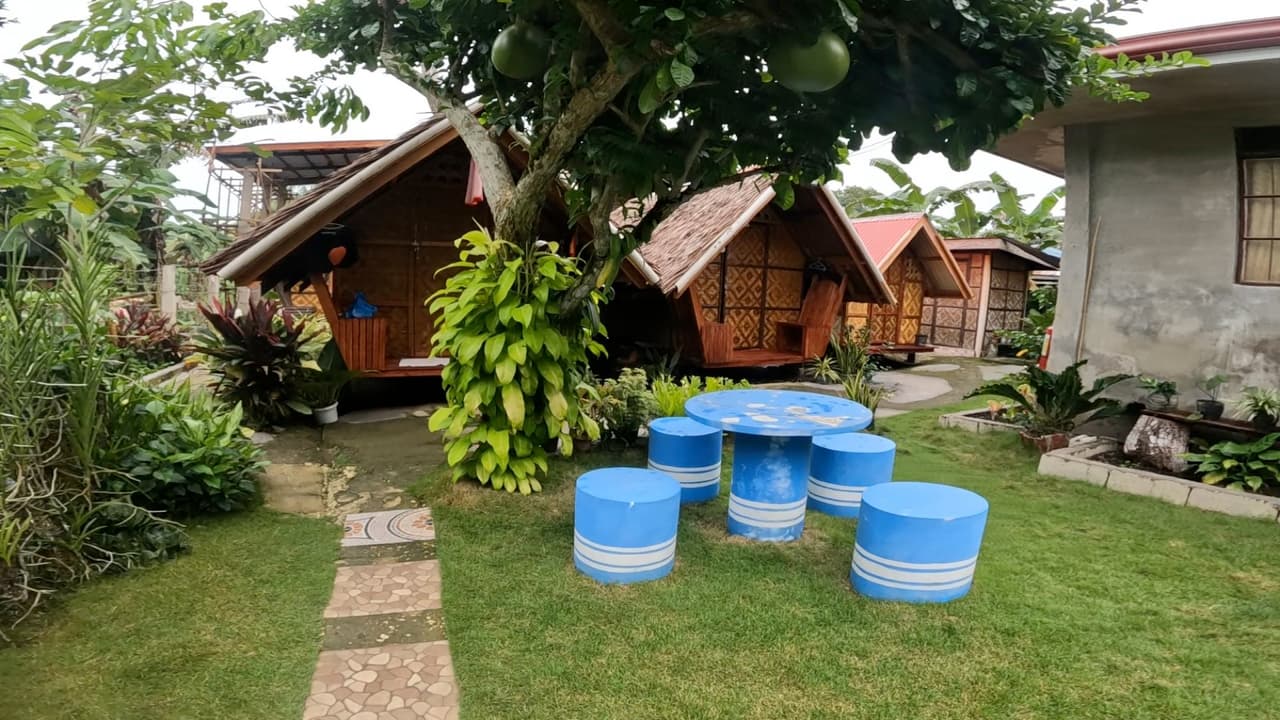 Traditional bahay kubo huts with thatched roofs at Lhoyjean Garden Hostel, Bohol, Philippines