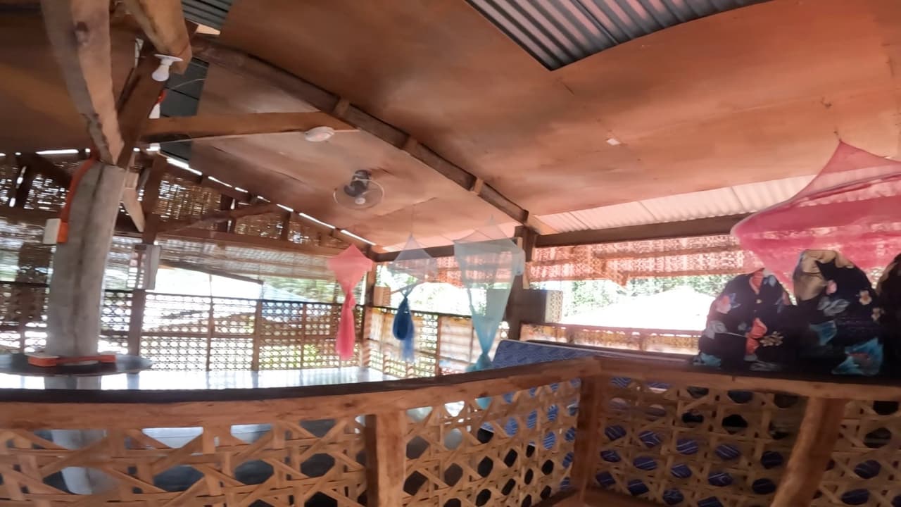 Open-air bamboo common area of a bahay kubo showing natural ventilation design