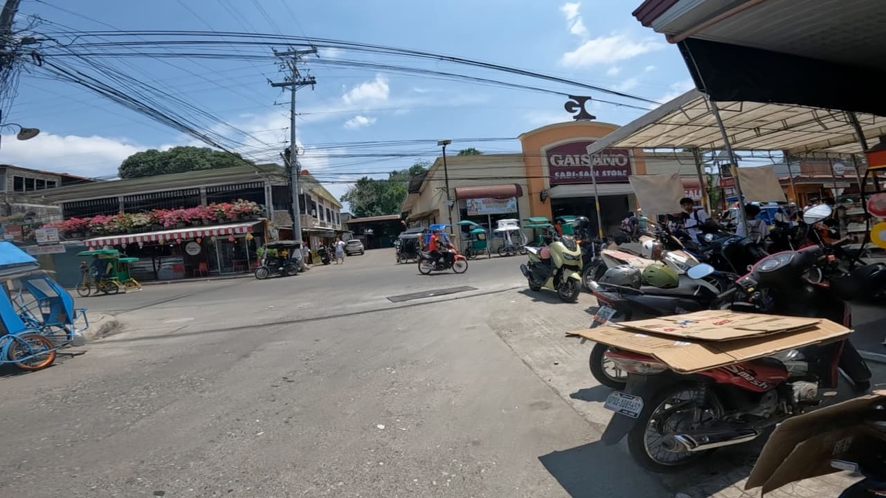 Busy town center of Balamban, Cebu with tricycles and motorbikes in front of the Gaisano store