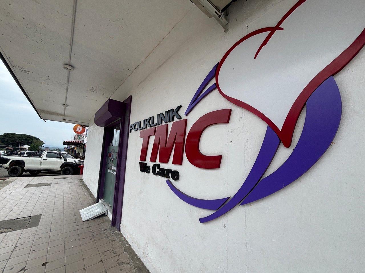 The signage for Poliklinik TMC, "We Care," on a storefront