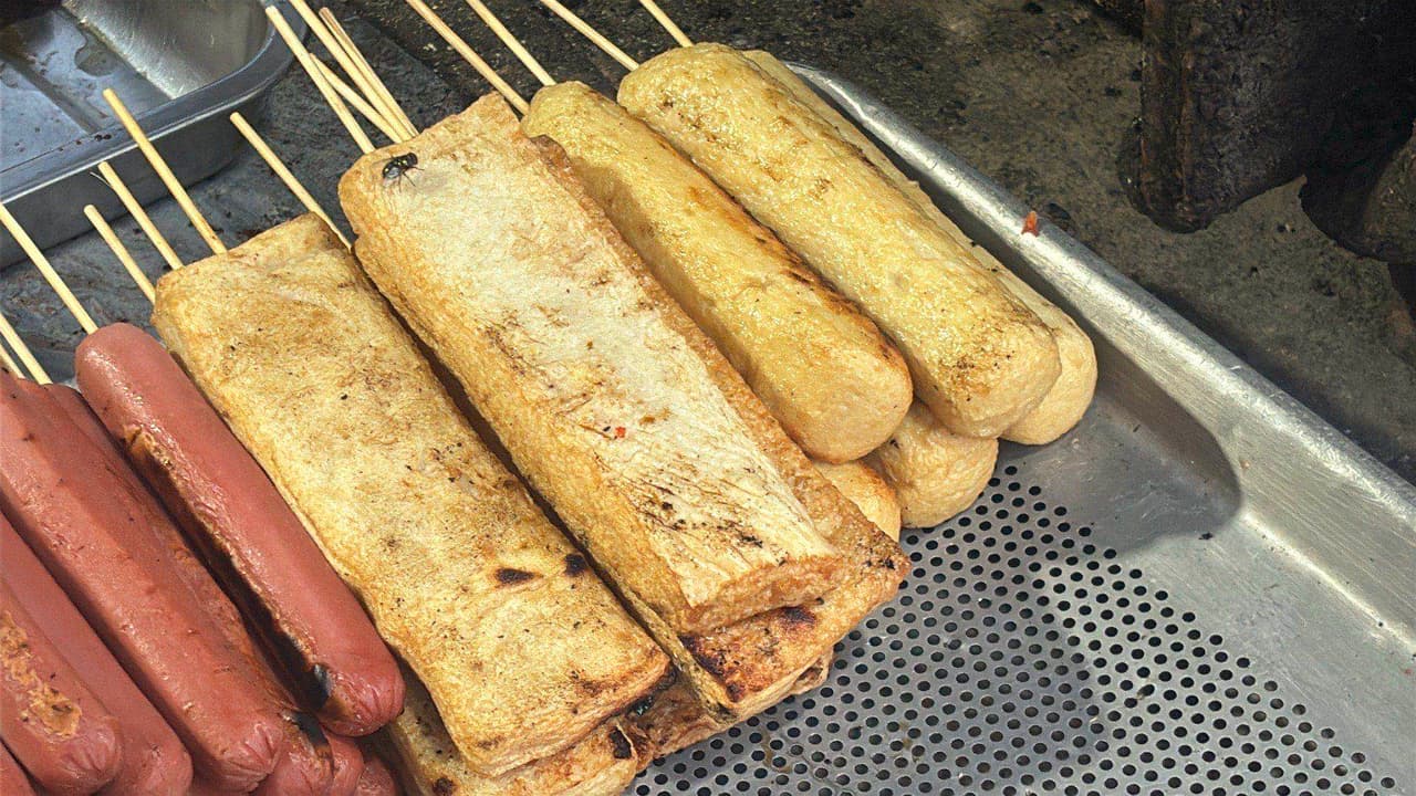 Grilled fish cakes and sausages on skewers at a Lawas food stall
