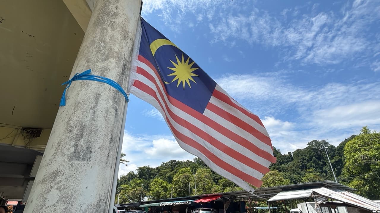 A Malaysian flag flying proudly just after the border