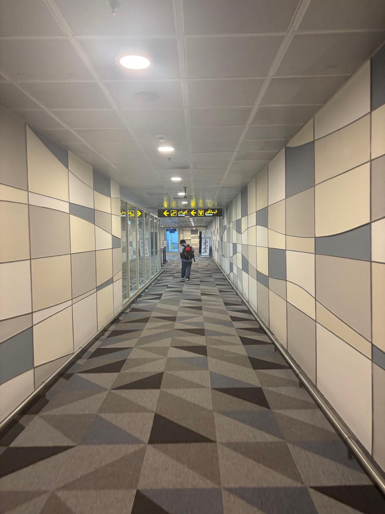 A sleek, geometric-patterned corridor inside Brunei International Airport