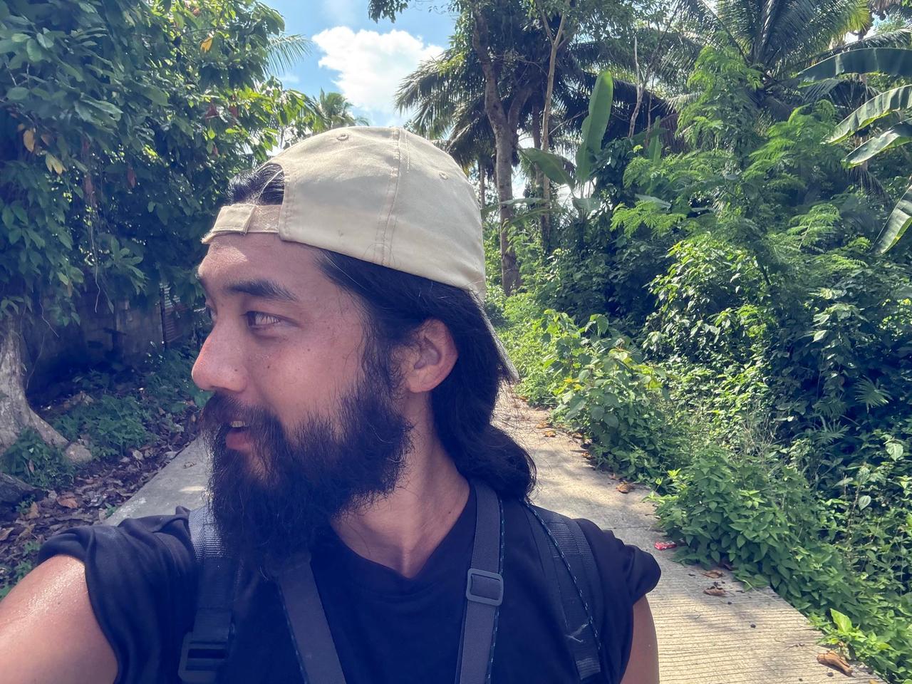 Walking along a jungle path lined with palm trees and dense greenery