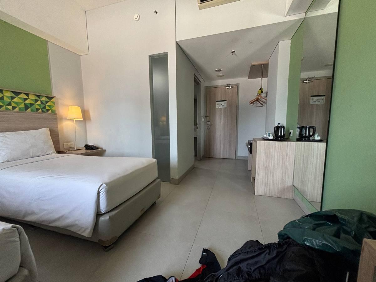 The new hotel room in Makassar, bags dropped on the floor after checking in