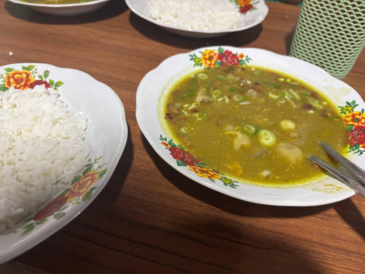 A steaming bowl of Sup Kikil beef tendon soup served with a plate of white rice