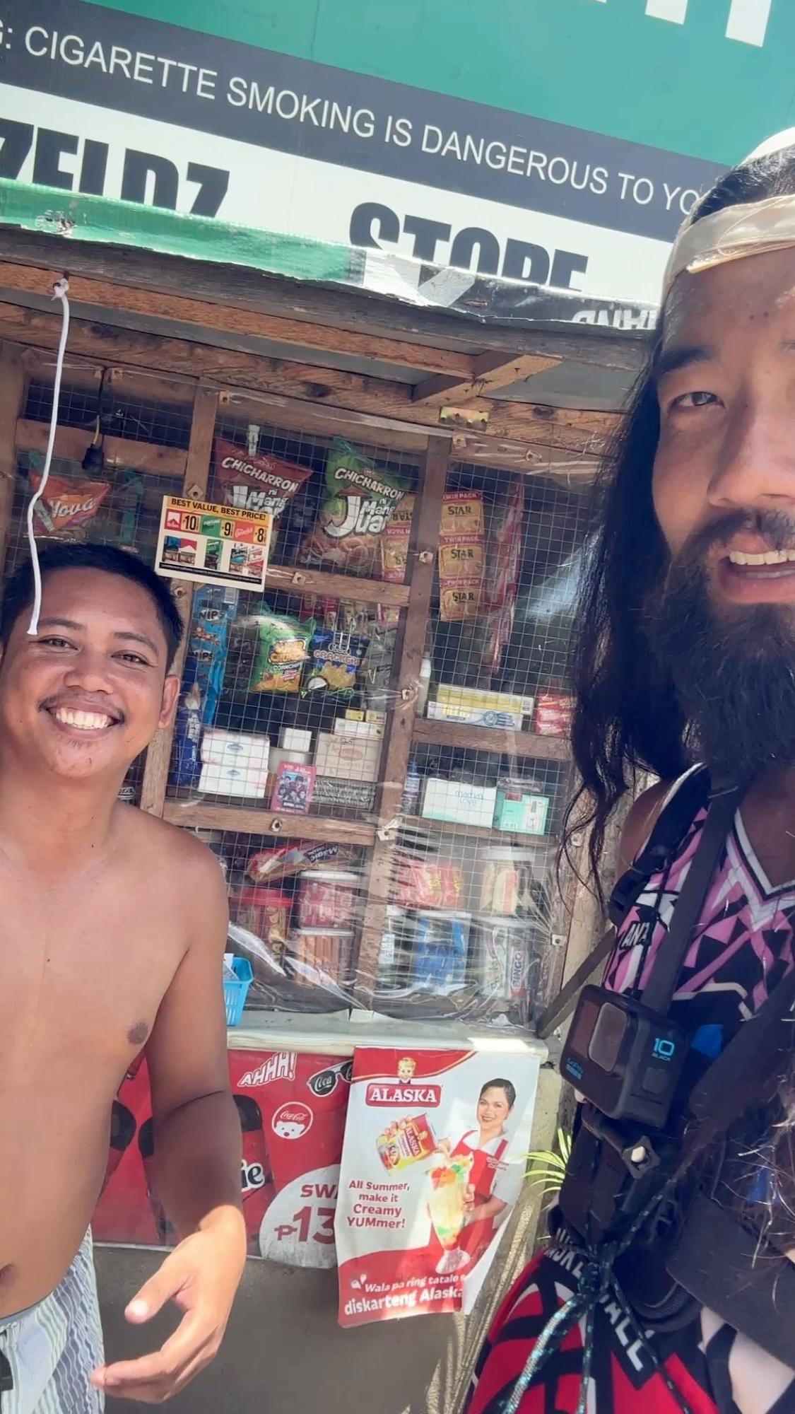 Posing for a photo with a friendly local at a sari-sari store along the road