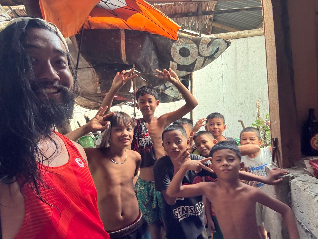 A big group of laughing local kids gathering around for a photo in the village of Polo