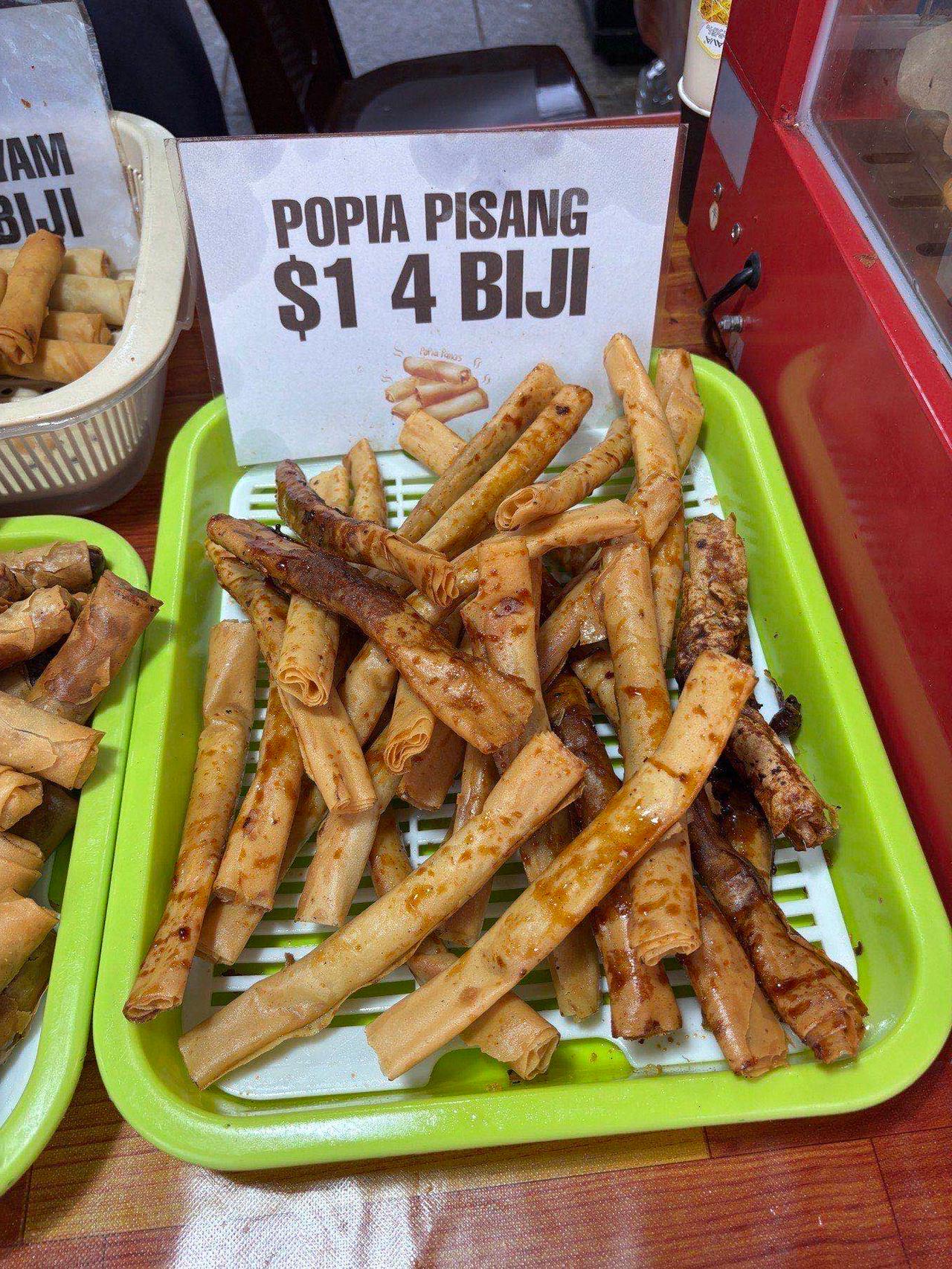 A tray of popia pisang, a sweet fried banana snack, at a Bangar food stall
