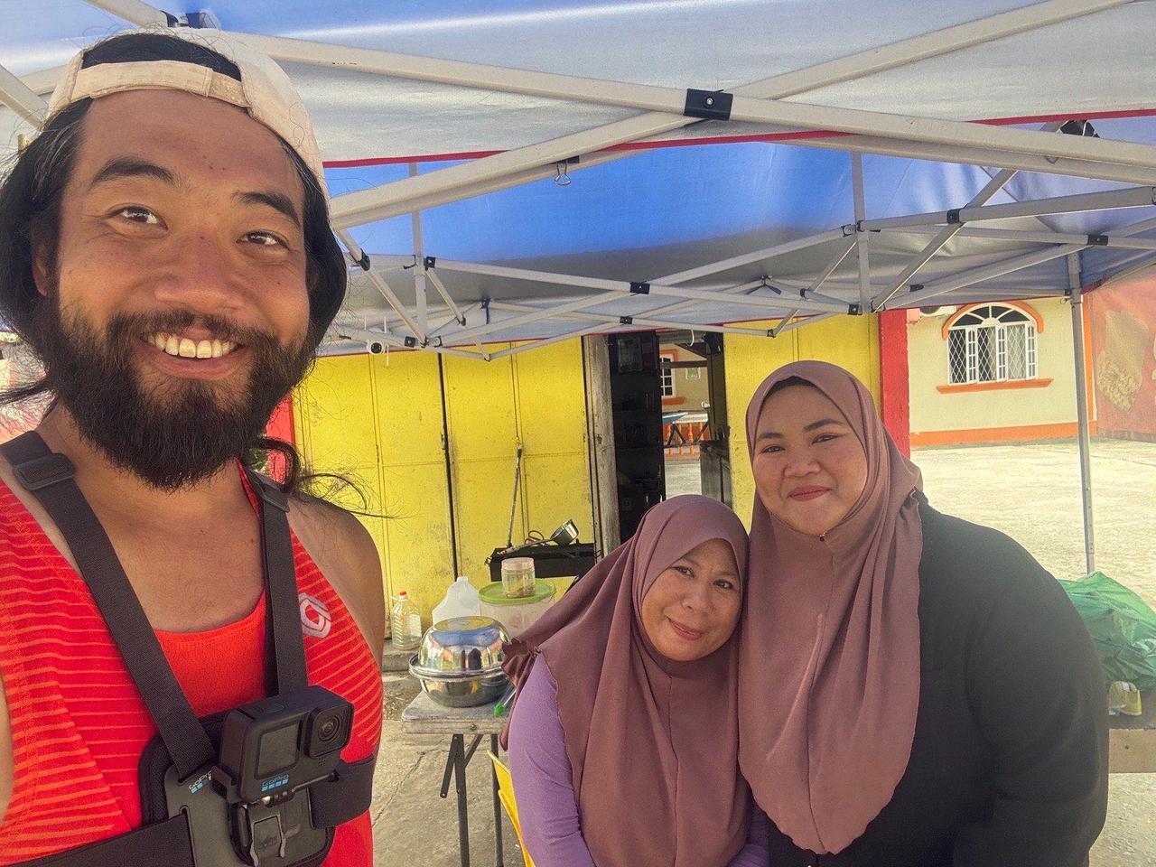 Chatting and taking photos with the ladies at a roadside food stall