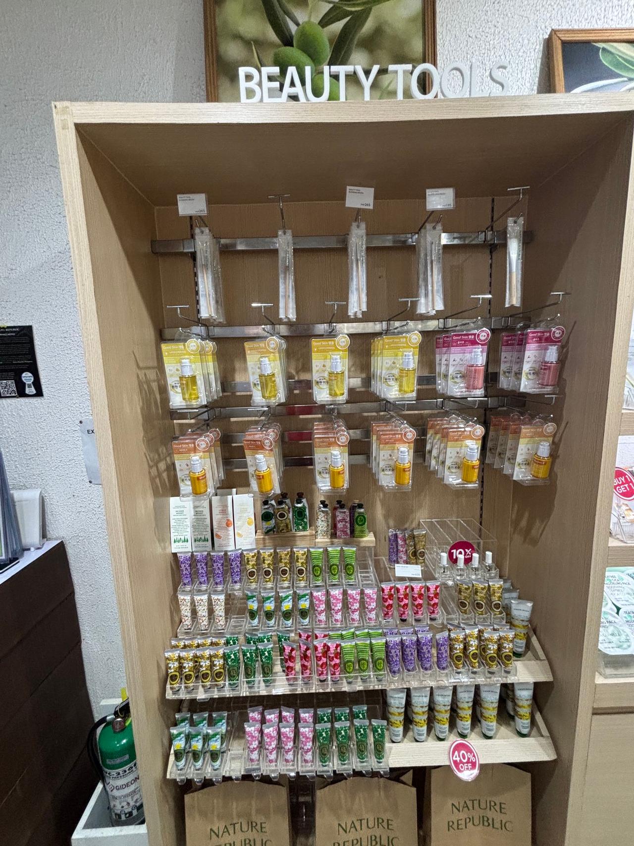 A store shelf displaying various beauty products and hand creams at Ayala Mall