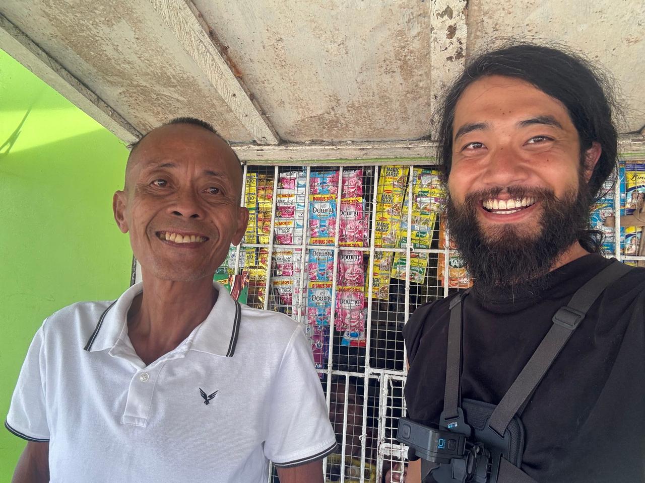 Standing together with the local village captain who offered a place to stay for the night