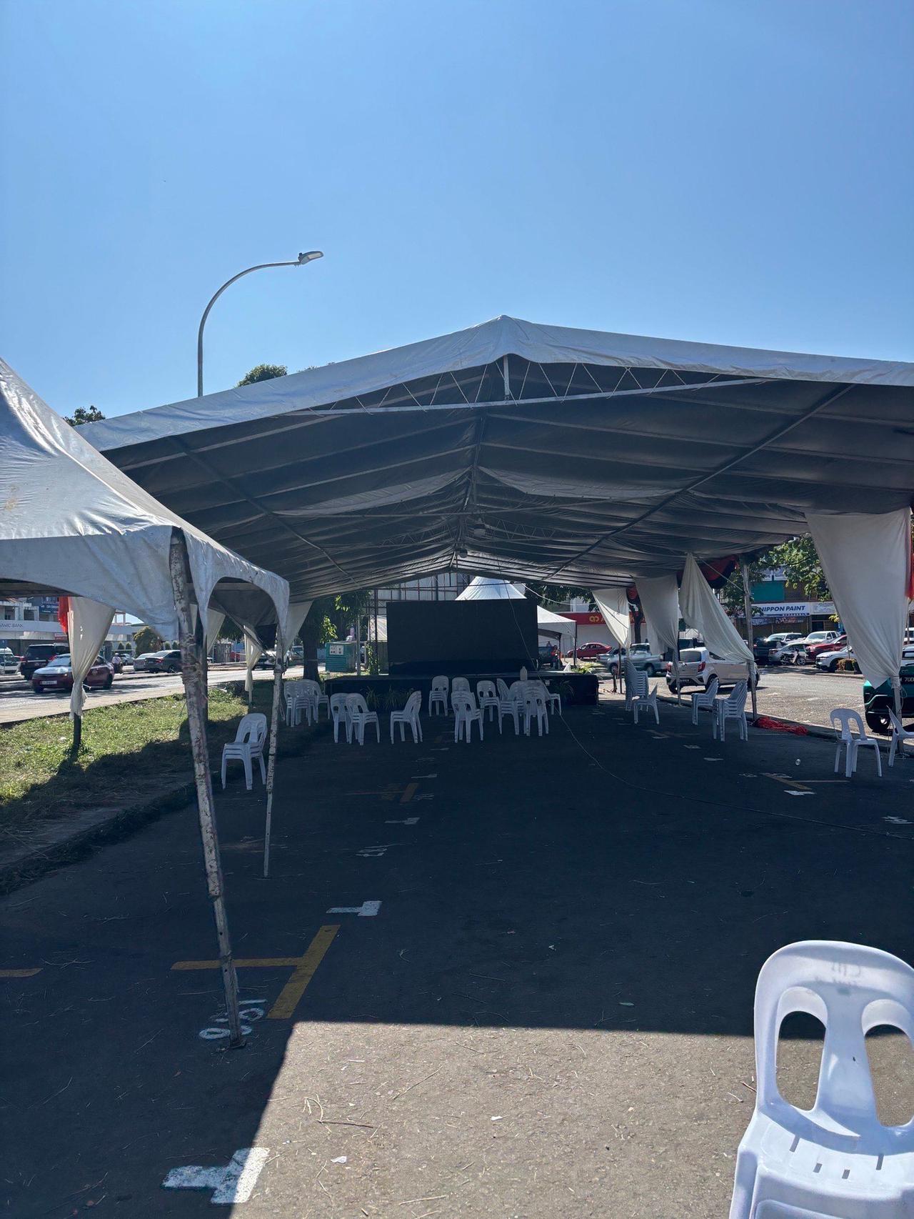 The empty festival grounds, just white plastic chairs and bare tents left behind