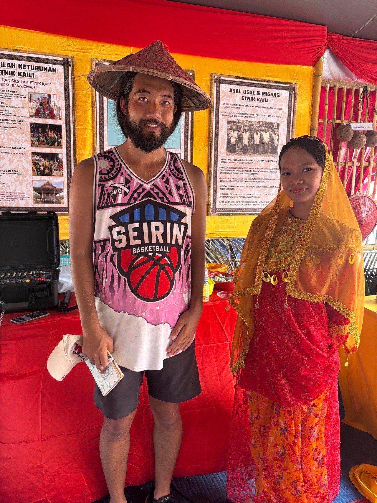 Posing with a woman in traditional Kaili dress at their booth