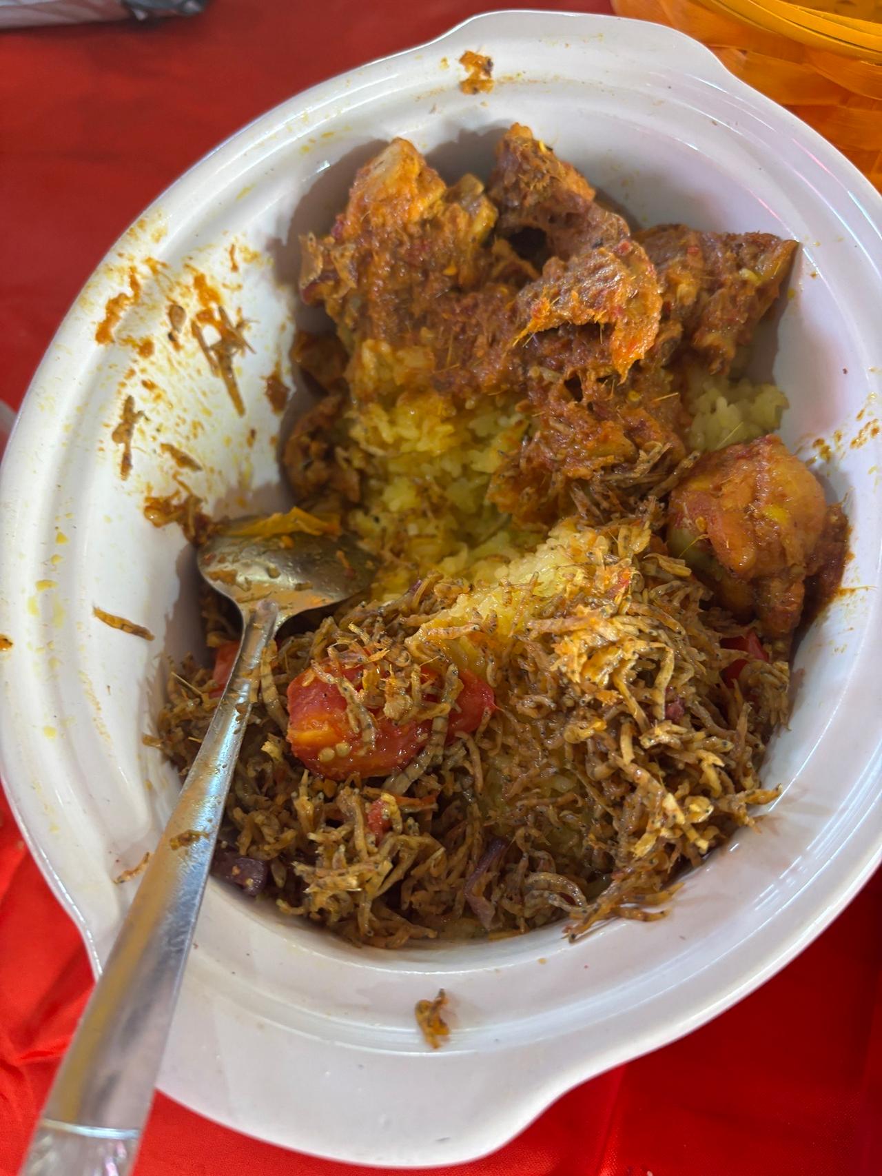 A bowl of Duo, a Kaili rice dish topped with spiced meat and shredded anchovies
