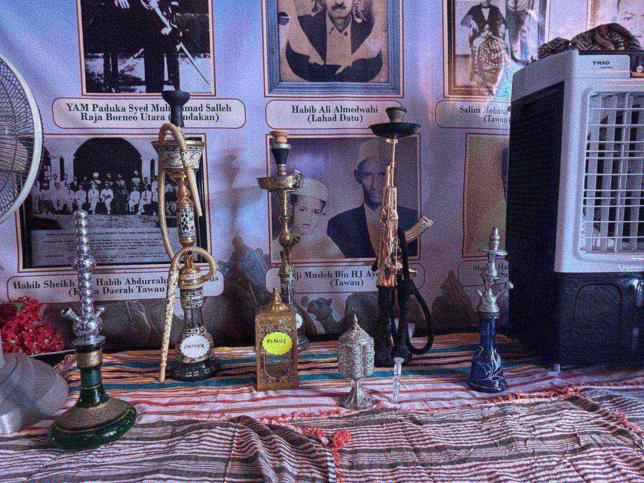 A display of ornate shisha pipes, including a rifle-shaped one, at the Arab booth