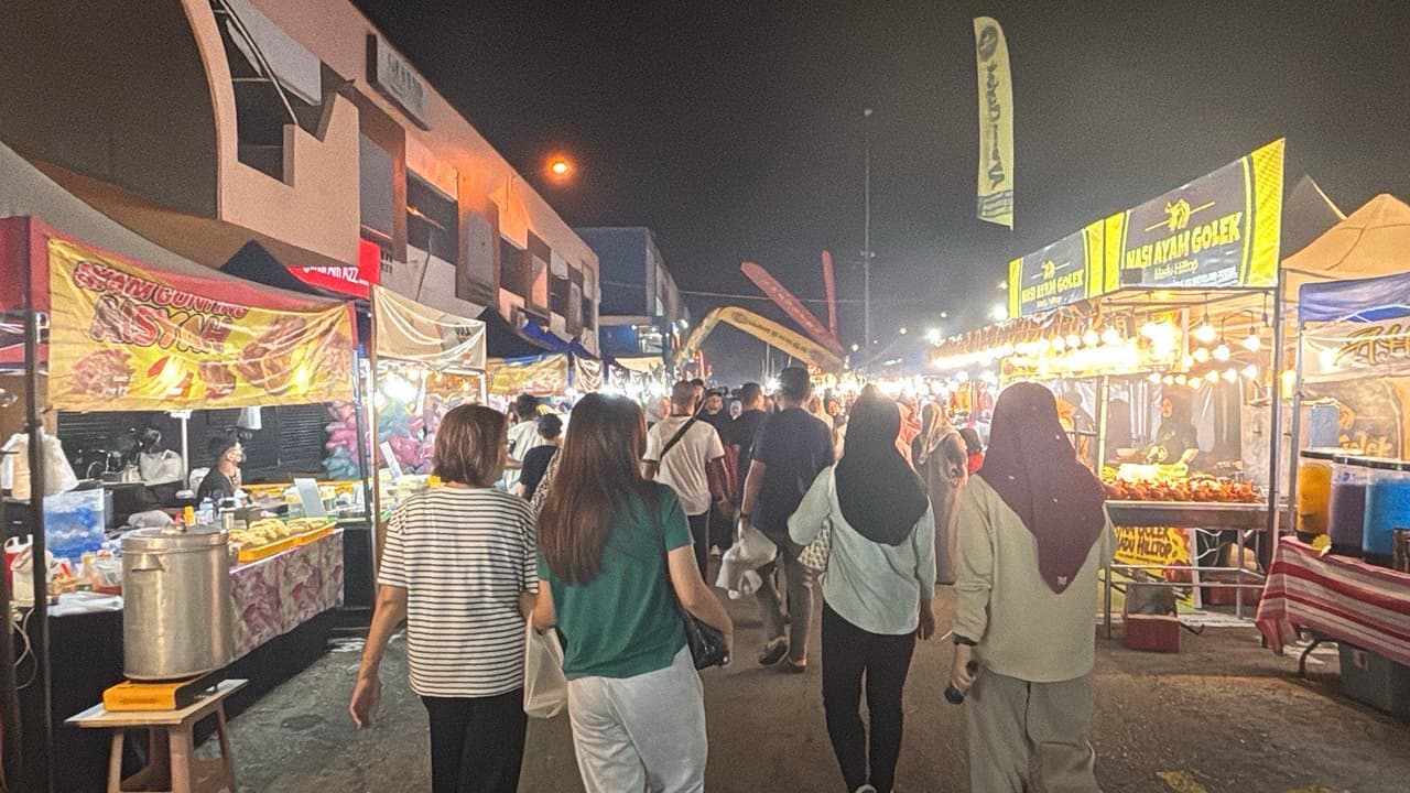 Walking through the illuminated night market food stalls