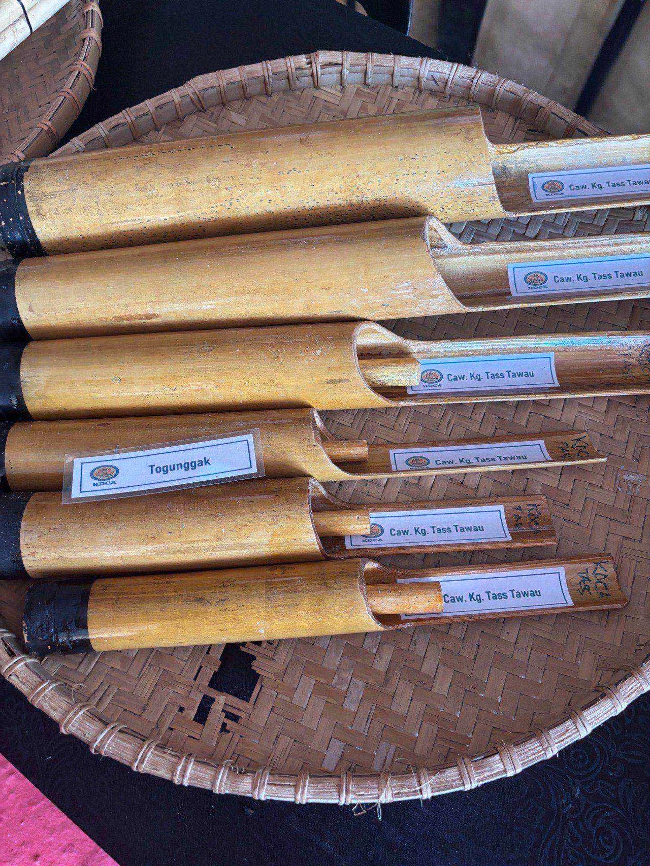 A set of traditional Toraja bamboo instruments in a woven basket