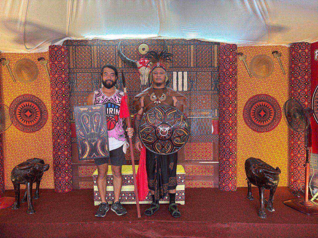 Posing with a warrior in traditional Toraja costume and shield