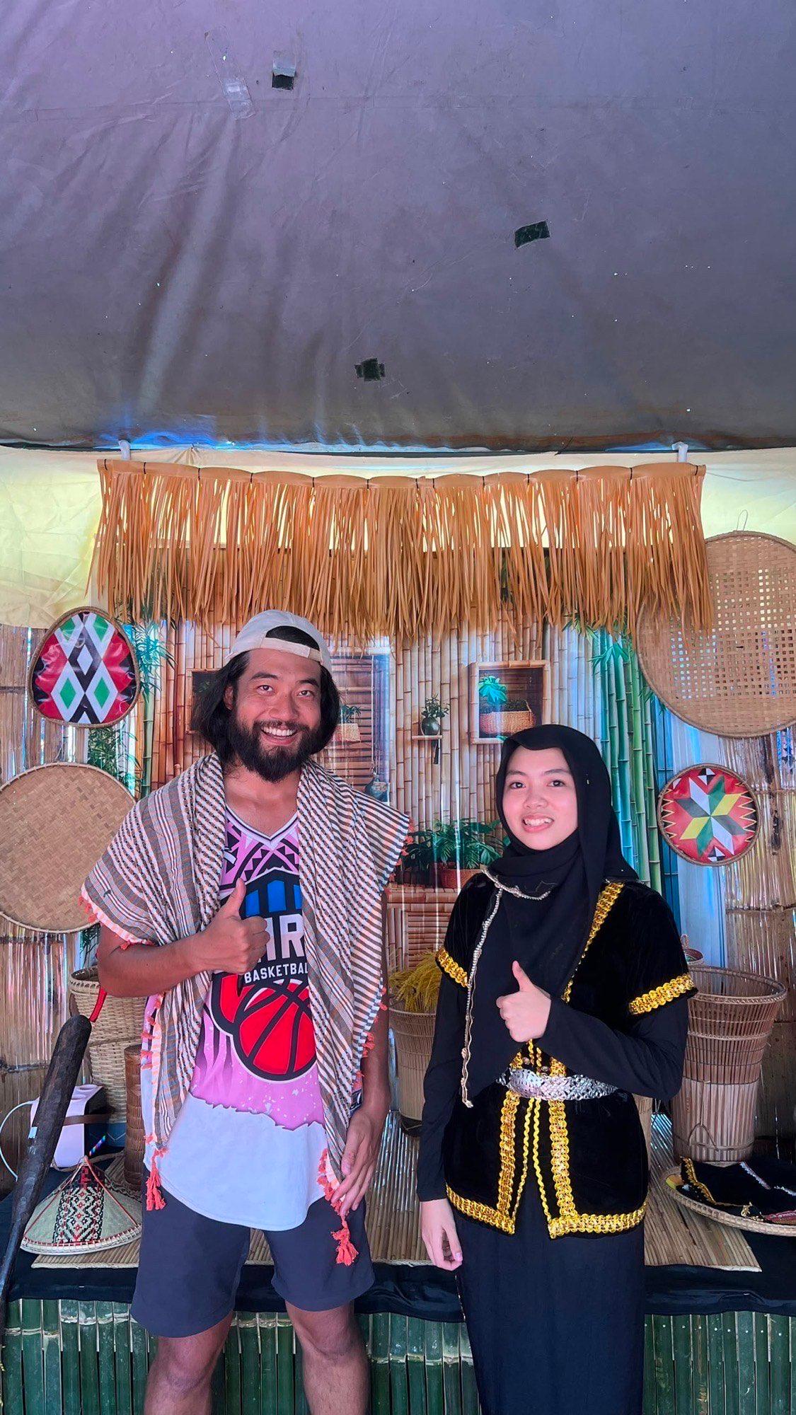 Posing with a girl at the Toraja booth who practiced her Japanese with me