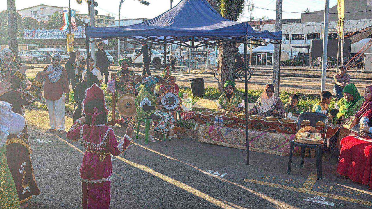 Dancers in traditional dress performing to gong music on the street