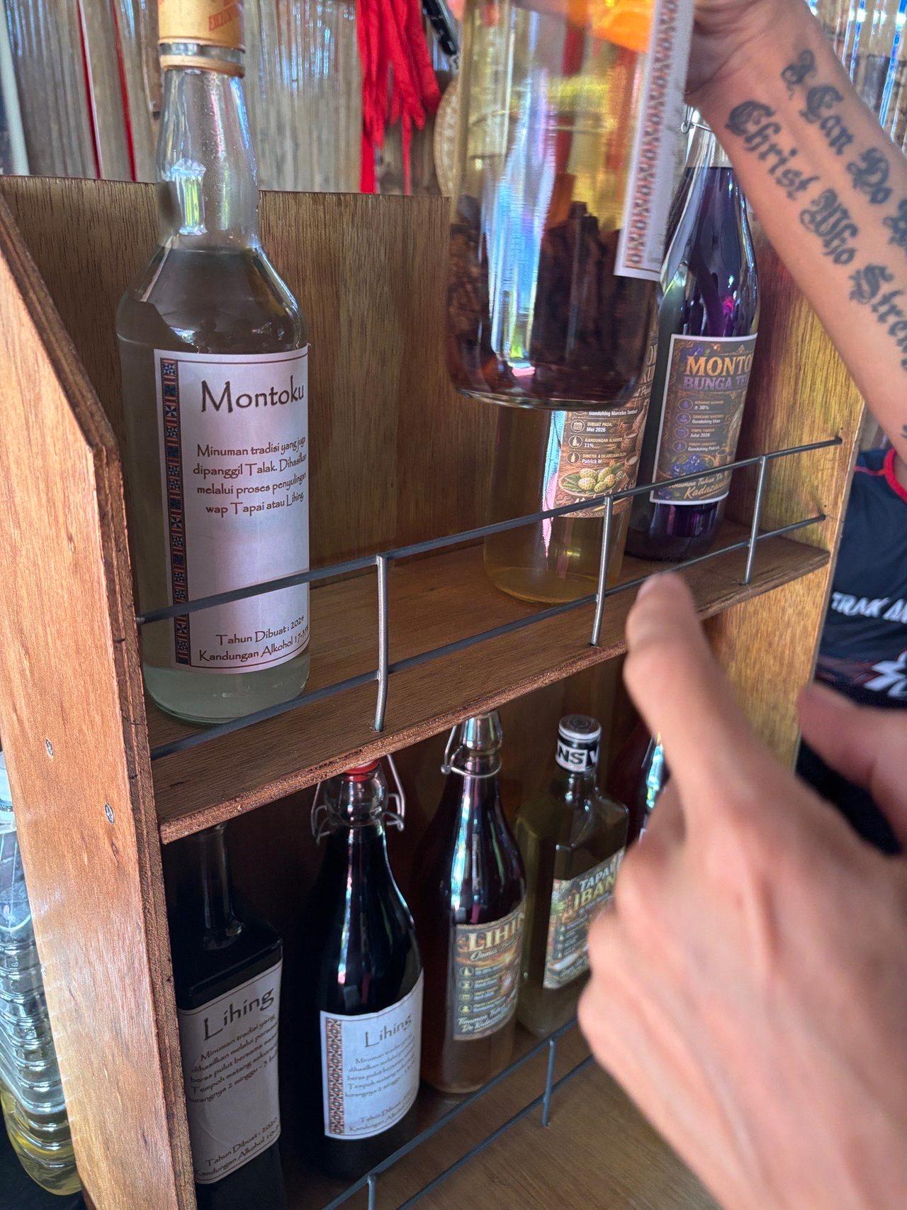 Bottles of Montoku and Lihing traditional rice wine on a wooden shelf