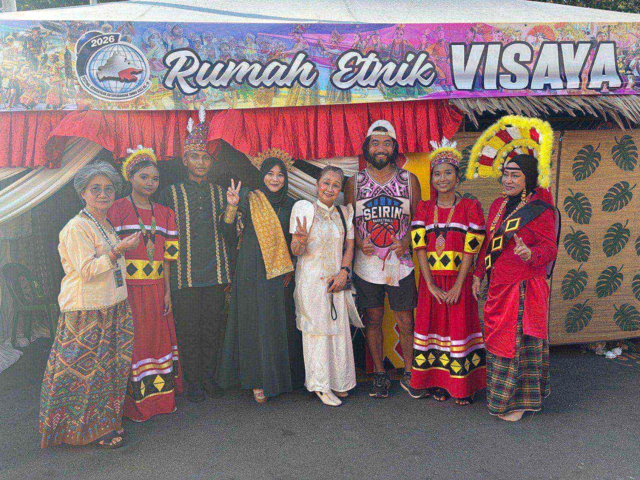 A group photo in front of the "Rumah Etnik Visaya" booth with locals in traditional dress