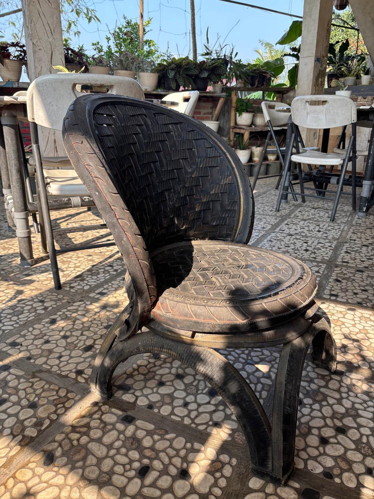 A handmade chair woven and shaped entirely from repurposed rubber tires