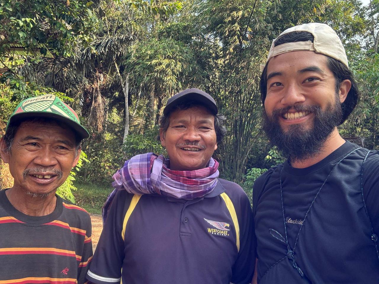 A photo with two local men met along the forest path